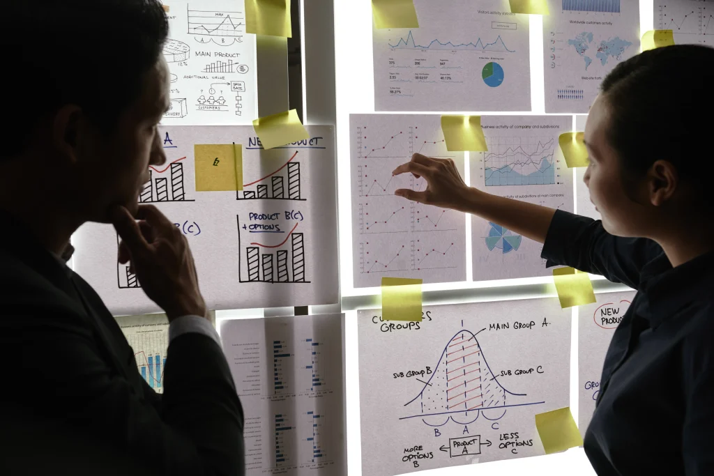 Enterprise leaders analyzing business performance reports and operational insights during an AI-powered legacy application modernization project designed to increase agility and scalability